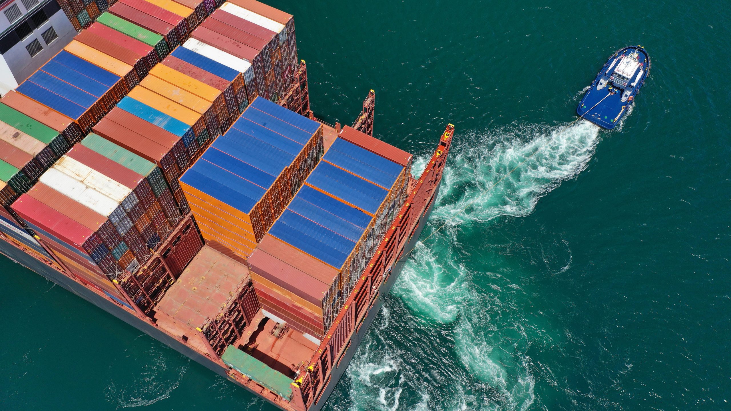 aerial,drone,photo,of,tug,boats,manoeuvring,huge,container,carrier aerial,drone,photo,of,tug,boats,manoeuvring,huge,container,carrier